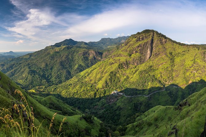 The dark entrance of Ravana Cave surrounded by cliff vegetation near Ella.