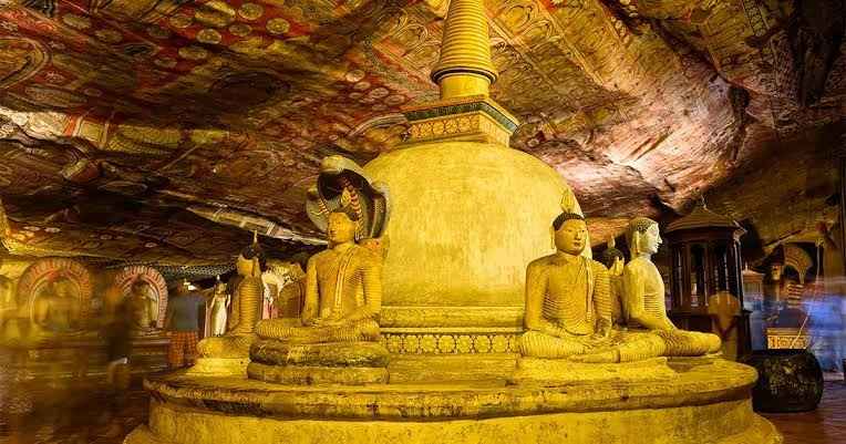 Golden Temple of Dambulla - Intricately painted rock ceiling murals and rows of seated Buddha statues inside Cave 2