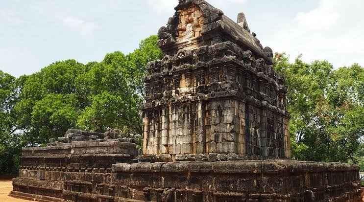 The Temple of Nalanda Gedige front stone facade surrounded by reservoir waters in Matale