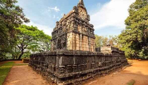 Intricate stone pilasters and dwarf carvings on the exterior of the Temple of Nalanda Gedige
