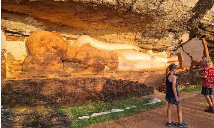 Ancient brick reclining Buddha statue along the hiking path at Pidurangala Rock