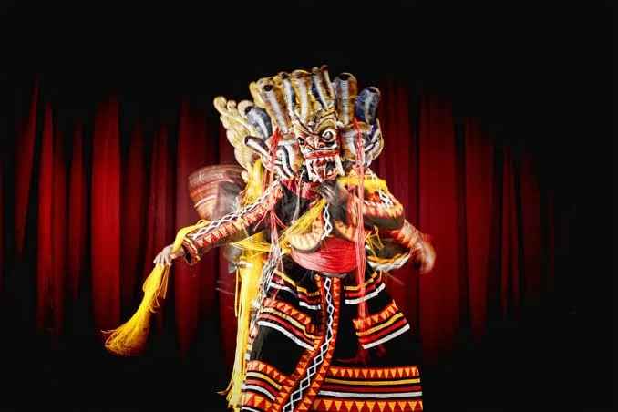 Low Country devil dancer wearing an authentic wooden mask during traditional dances of Sri Lanka