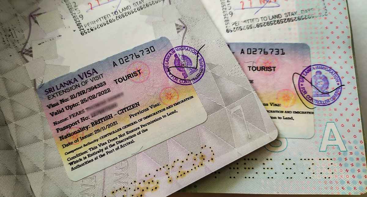 Tourist holding passport with Sri Lanka entry stamp and travel documents