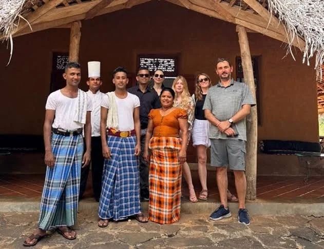 Friendly Sri Lankan locals greeting travelers with warm hospitality.