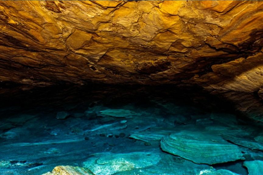 Subterranean cavern and turquoise waters inside Nil Diya Pokuna near Ella.
