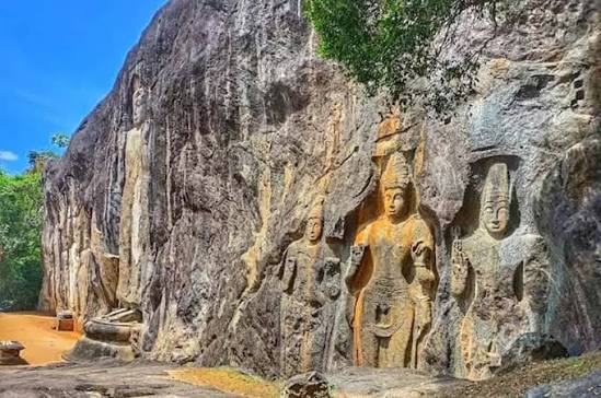 Giant standing Buddha statue carved into the rock at Buduruwagala Temple Sri Lanka