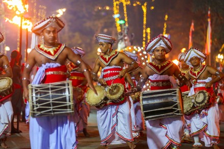 Vibrant night procession of Kandyan dancers and drummers at the Kandy Esala Perahera festival.